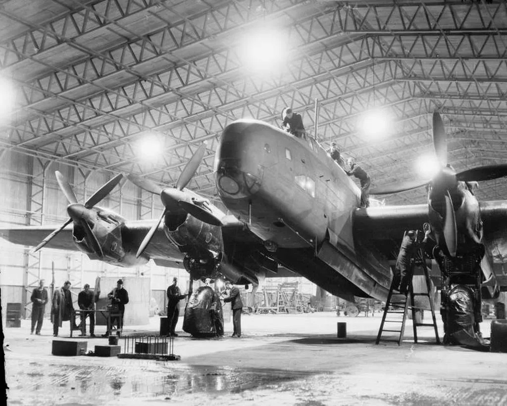 A Handley Page Halifax bomber under night maintenance inside a T2 hangar at Tockwith during the Second World War